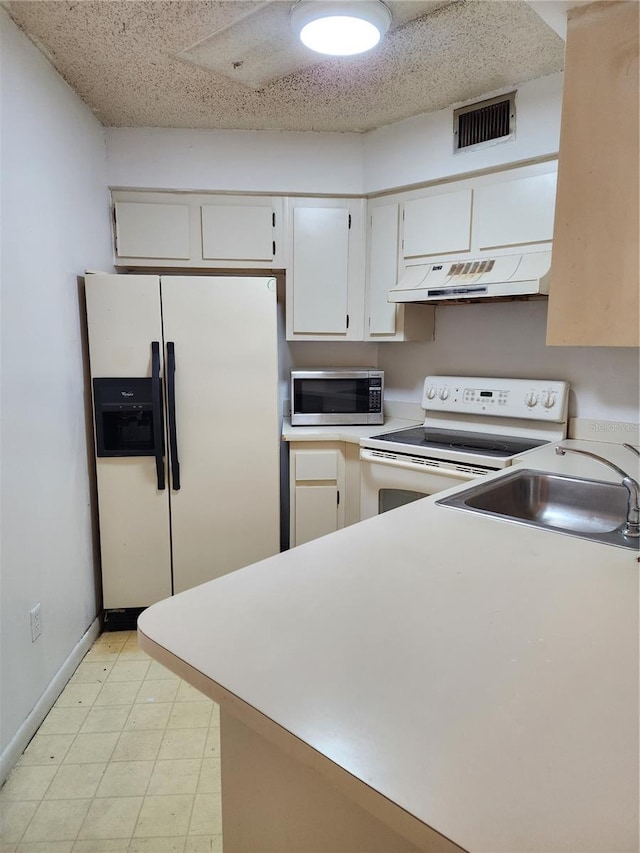 kitchen featuring white cabinets and white appliances