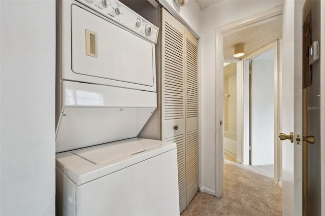 laundry area with light carpet and stacked washing maching and dryer