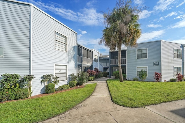 view of property's community with a lawn