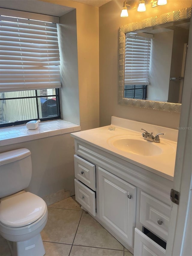 bathroom featuring vanity, toilet, and tile patterned floors