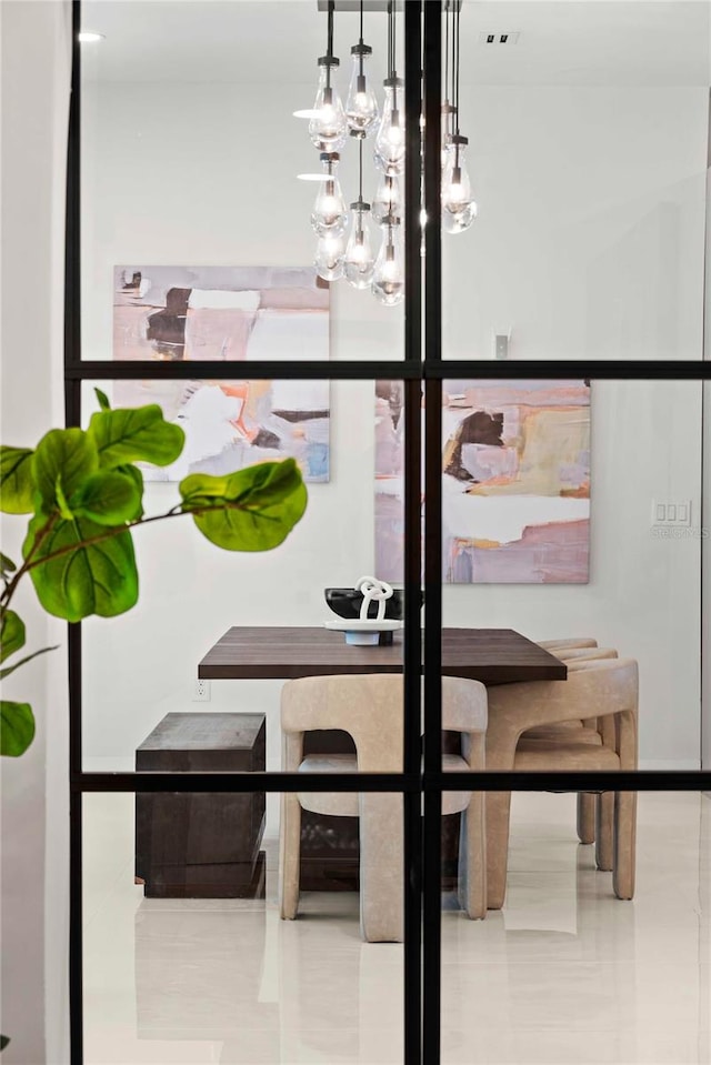 room details featuring a chandelier and tile patterned floors