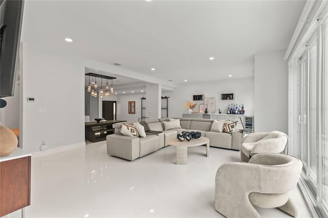 tiled living room with a notable chandelier and a wealth of natural light