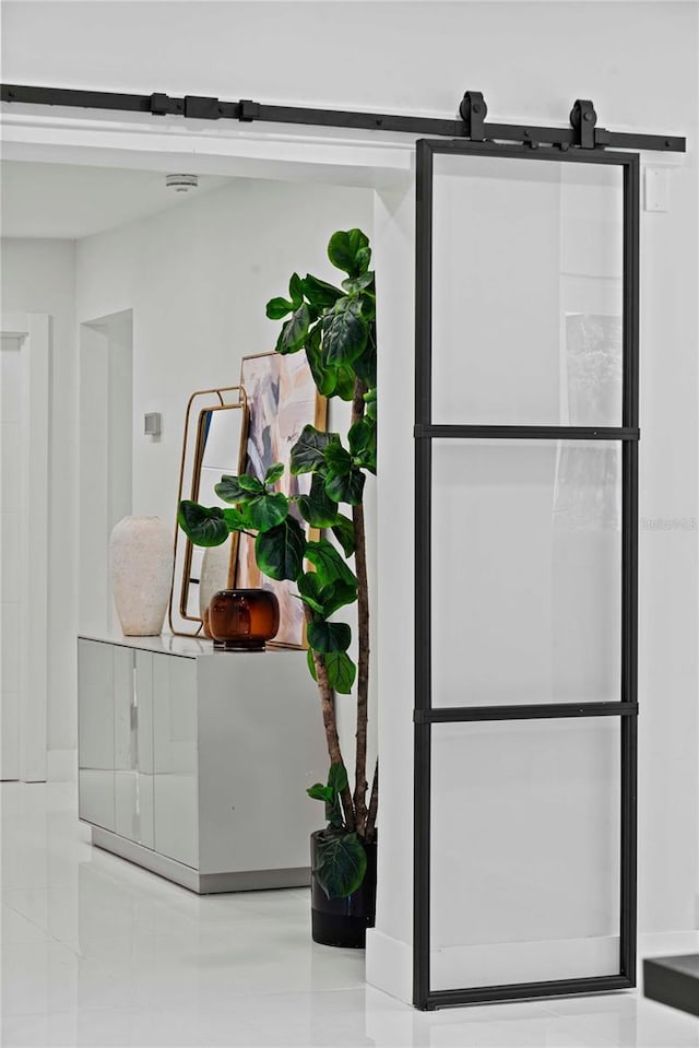 details featuring a barn door and tile patterned floors