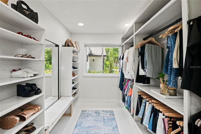 spacious closet with light tile patterned floors