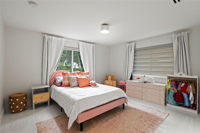 bedroom featuring light tile patterned flooring