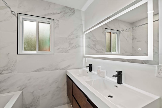 bathroom featuring tiled shower / bath combo and vanity