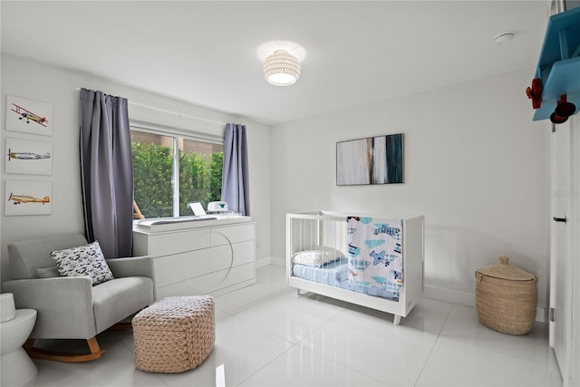 tiled bedroom featuring a crib