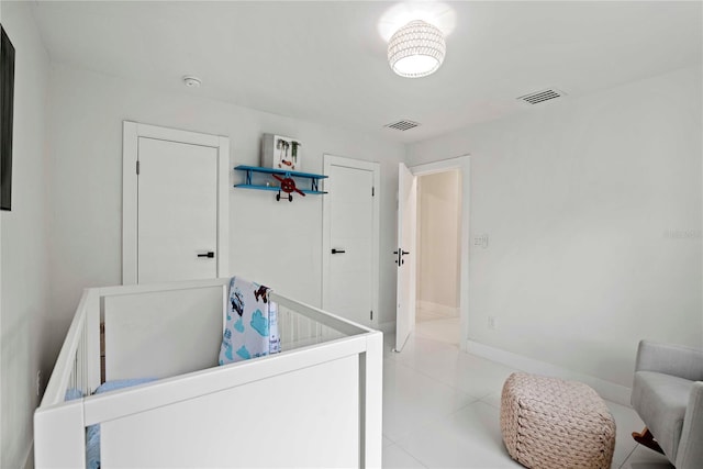 bedroom with light tile patterned floors