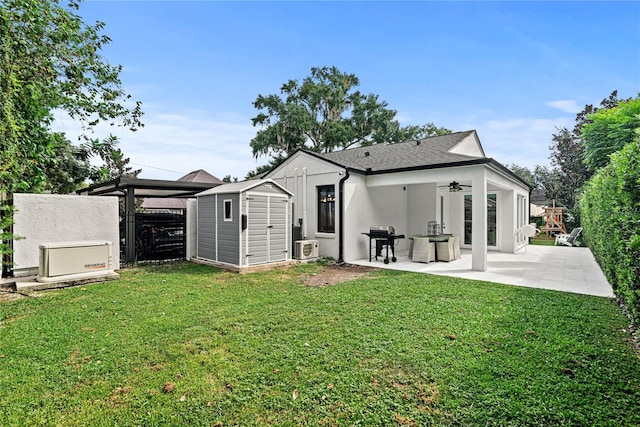 back of house featuring a patio area, a shed, and a yard