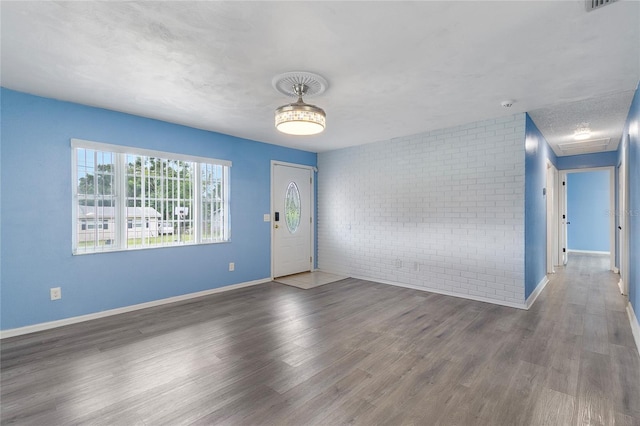 926 Everett St, Lake Alfred, FL 33850 - foyer entrance featuring brick wall, wood finished floors, and baseboards