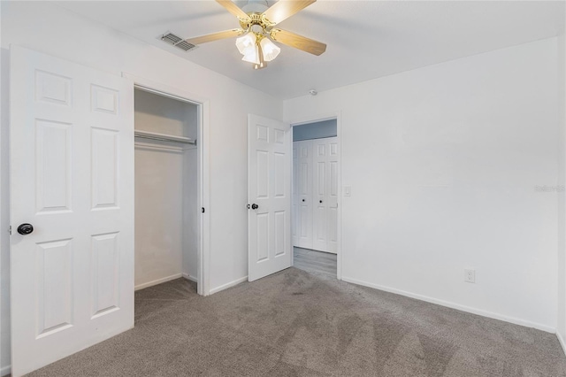 unfurnished bedroom with dark carpet and ceiling fan