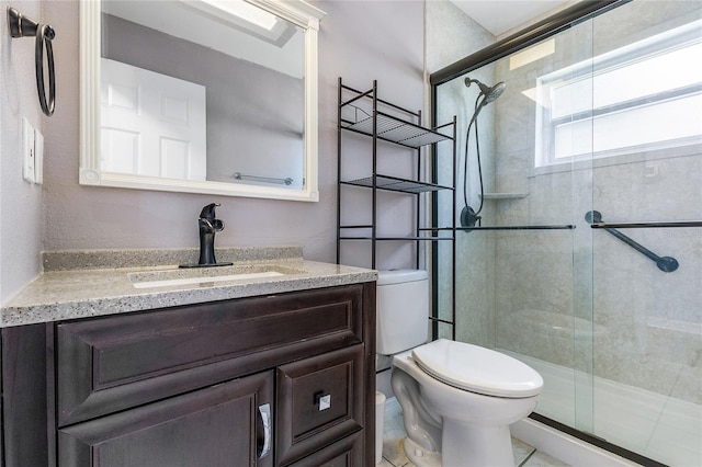 bathroom with toilet, vanity, and walk in shower