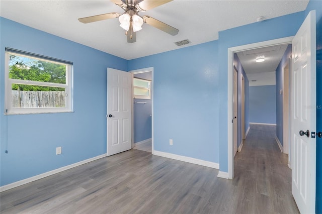 926 Everett St, Lake Alfred, FL 33850 - unfurnished bedroom with wood finished floors, baseboards, ceiling fan, and a closet
