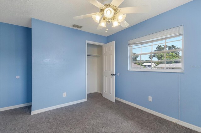 unfurnished bedroom with carpet flooring, a closet, and ceiling fan