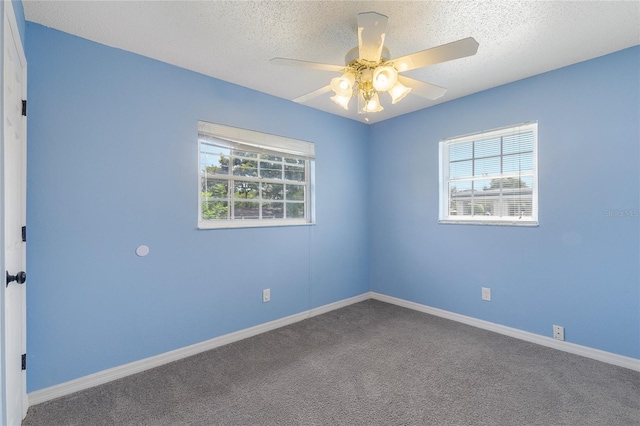 carpeted empty room featuring a textured ceiling and ceiling fan