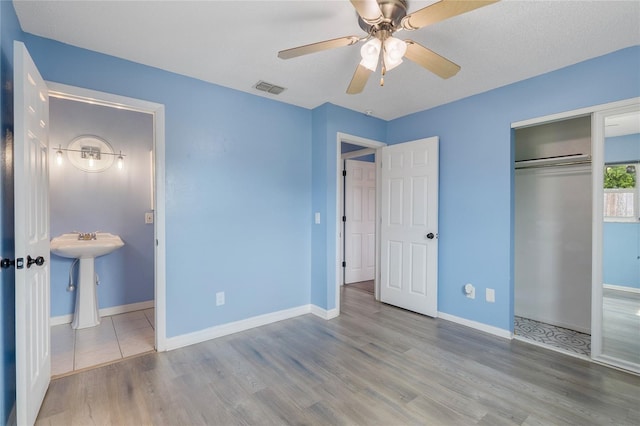 926 Everett St, Lake Alfred, FL 33850 - unfurnished bedroom with wood finished floors, a closet, baseboards, and a ceiling fan