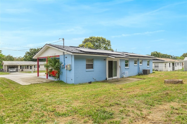 back of house with an outdoor fire pit, a patio area, central AC unit, and a yard