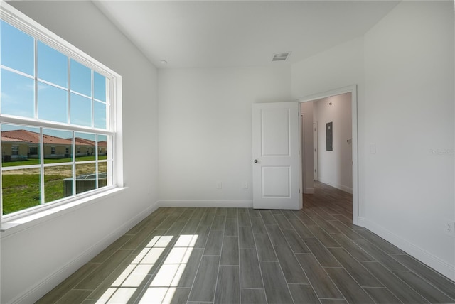 spare room with dark hardwood / wood-style floors