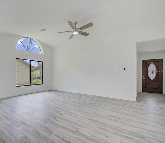 unfurnished living room featuring vaulted ceiling, ceiling fan, and light hardwood / wood-style flooring