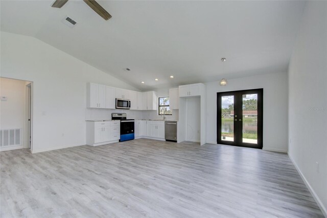 unfurnished living room featuring light hardwood / wood-style flooring, ceiling fan, high vaulted ceiling, and french doors