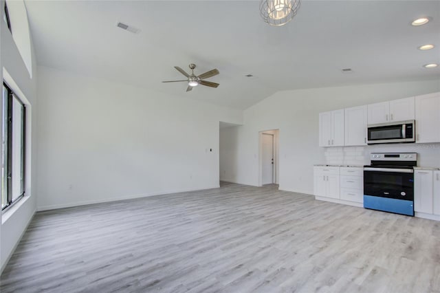 kitchen with ceiling fan, appliances with stainless steel finishes, vaulted ceiling, and white cabinetry