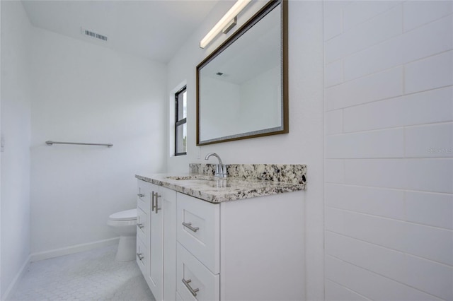 bathroom with vanity and toilet