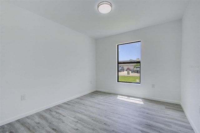 empty room with light hardwood / wood-style flooring