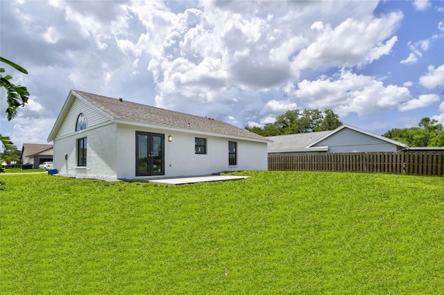 rear view of property with a lawn, a patio, and french doors