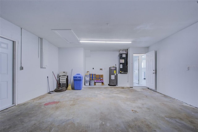 garage featuring heating unit and water heater