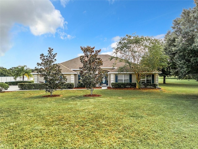 view of front of home featuring a front lawn and a shingled roof