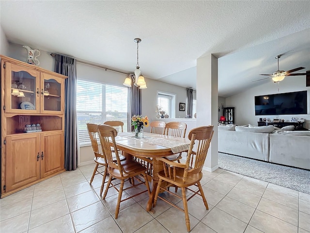 dining room featuring a ceiling fan, a textured ceiling, and light tile patterned floors