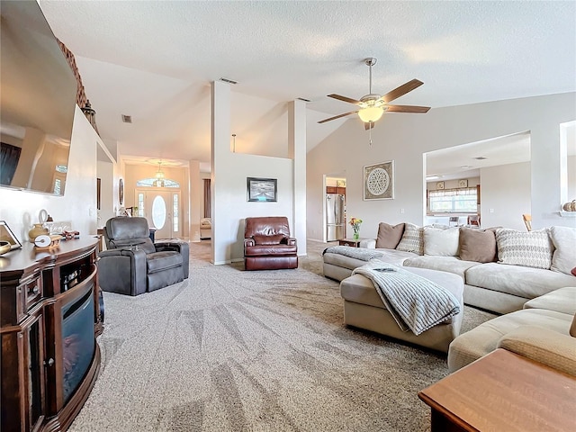 living room featuring ceiling fan, a textured ceiling, carpet flooring, and high vaulted ceiling