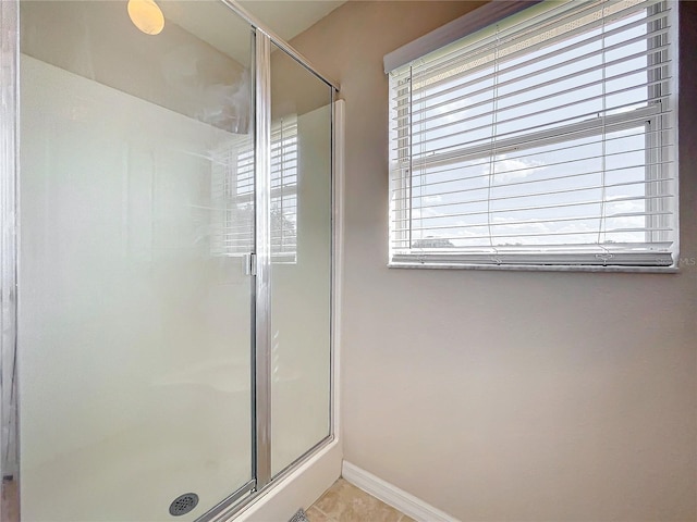 bathroom with walk in shower and tile patterned floors