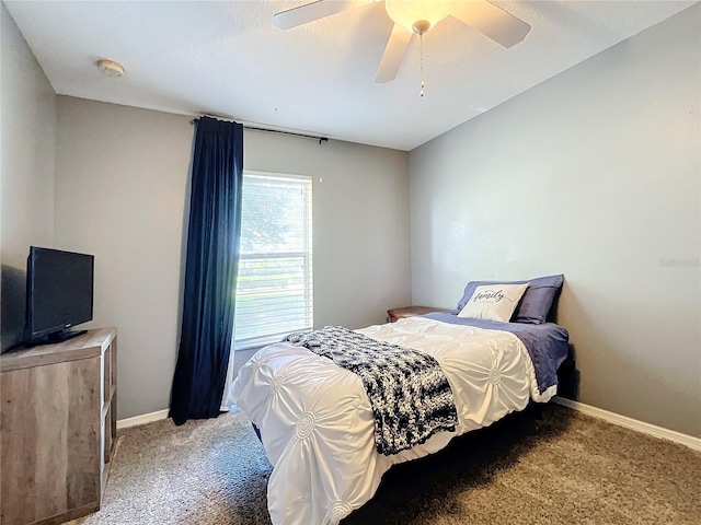 carpeted bedroom with a ceiling fan and baseboards