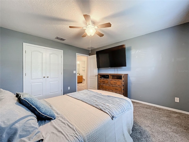 carpeted bedroom featuring a closet, ceiling fan, and a textured ceiling