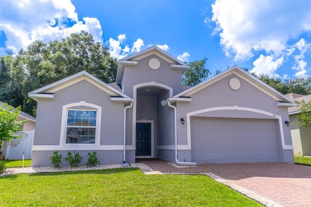 view of front of property with a garage and a front lawn