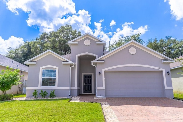 view of front of property featuring a garage and a front lawn