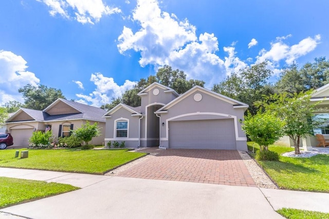 view of front of home with a garage and a front yard