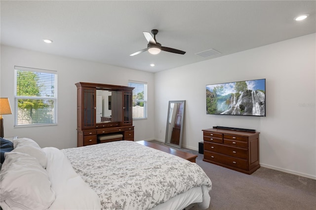 carpeted bedroom with ceiling fan and multiple windows