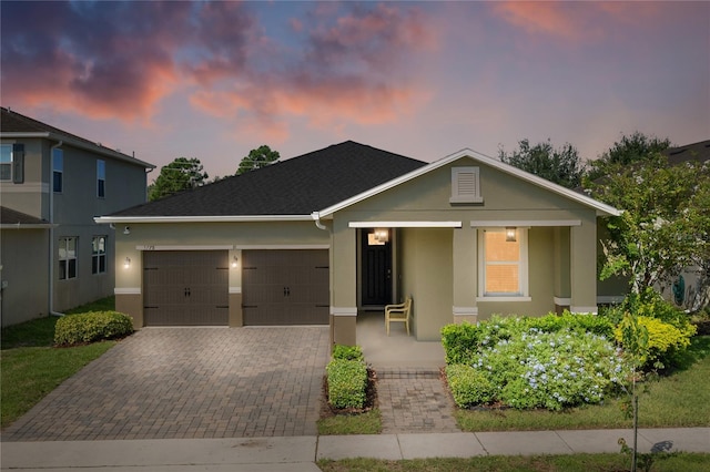 view of front of property featuring a porch and a garage