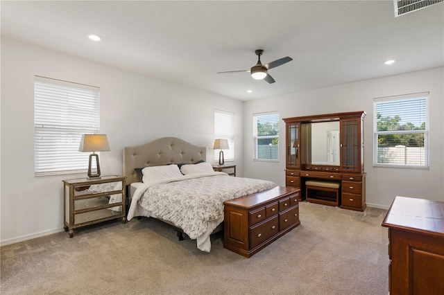 bedroom with ceiling fan and light carpet