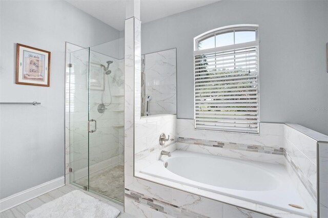 bathroom with separate shower and tub