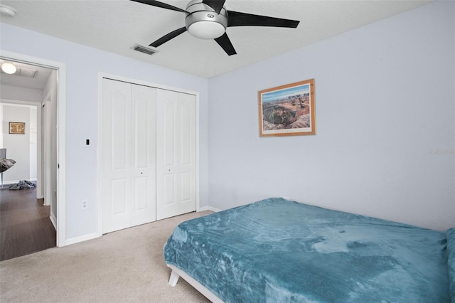 carpeted bedroom with a closet and ceiling fan