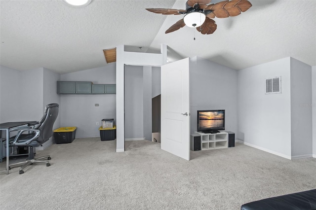 office area with ceiling fan, a textured ceiling, lofted ceiling, and light carpet