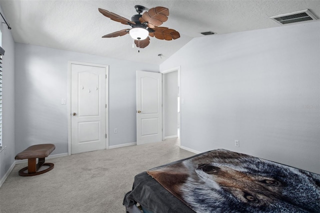 carpeted bedroom featuring ceiling fan, a textured ceiling, and lofted ceiling