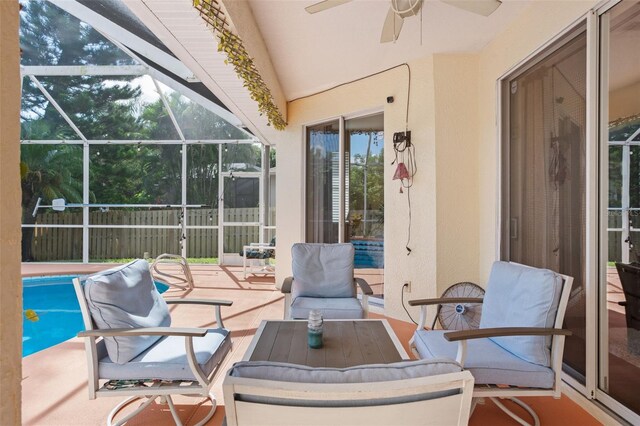 sunroom / solarium featuring lofted ceiling and ceiling fan