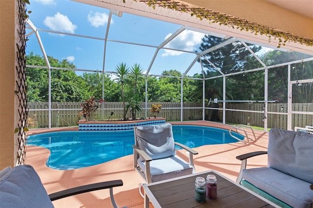 view of pool featuring a patio and glass enclosure