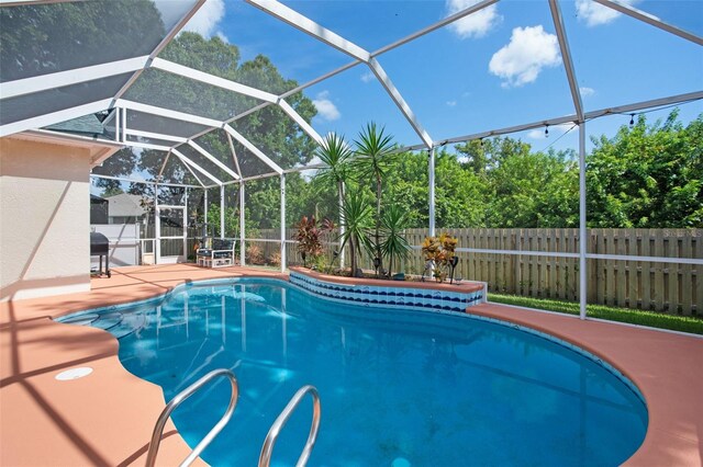 view of pool featuring a lanai and a patio