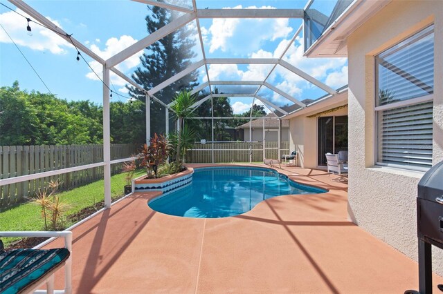 view of pool featuring a patio and glass enclosure