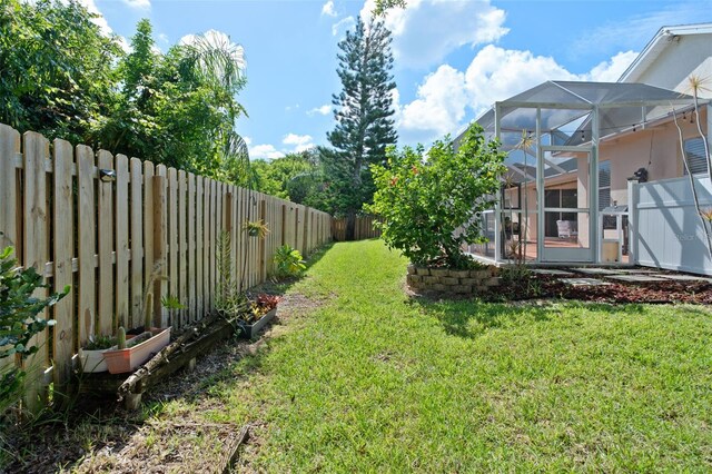 view of yard with glass enclosure